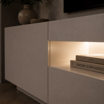Meuble TV moderne blanc avec rangement et LED intégrée, détail finition premium et éclairage doux.